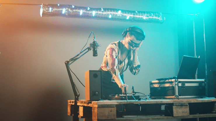 Professional DJ with lighting equipment at a live event, showcasing modern lighting solutions.